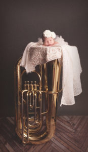 Little newborn captured on a tuba