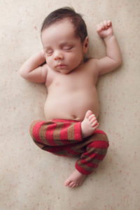 A newborn baby posing during a session with award-winning photographer Joanna Booth Photography in Katy Texas.