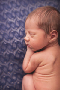 A newborn baby posing during a session with award-winning photographer Joanna Booth Photography in Katy Texas.