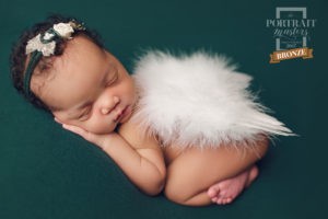 An image showcasing an award-winning picture of a newborn baby created by Joanna Booth of Joanna Booth Photography in Katy Texas.